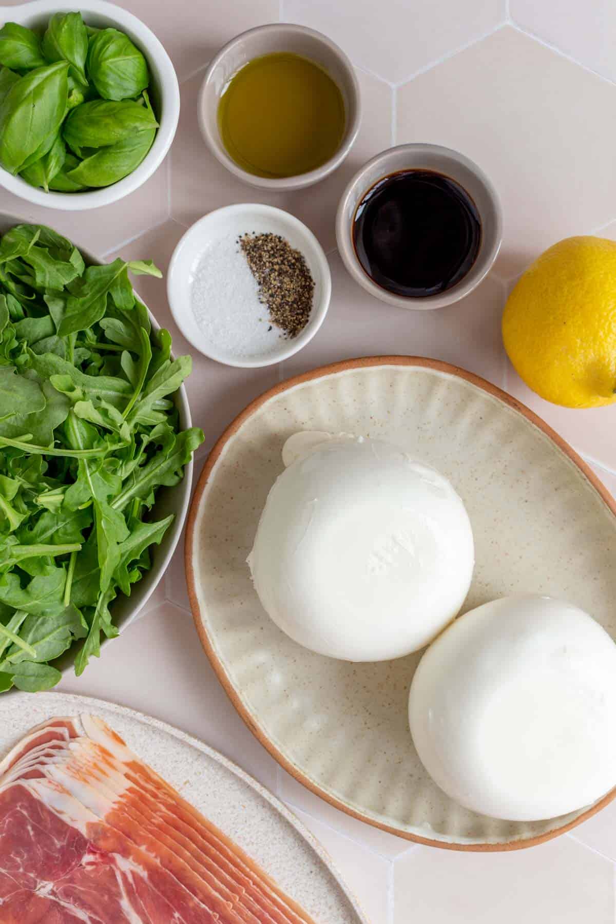 Ingredients needed to make prosciutto and burrata arugula salad.