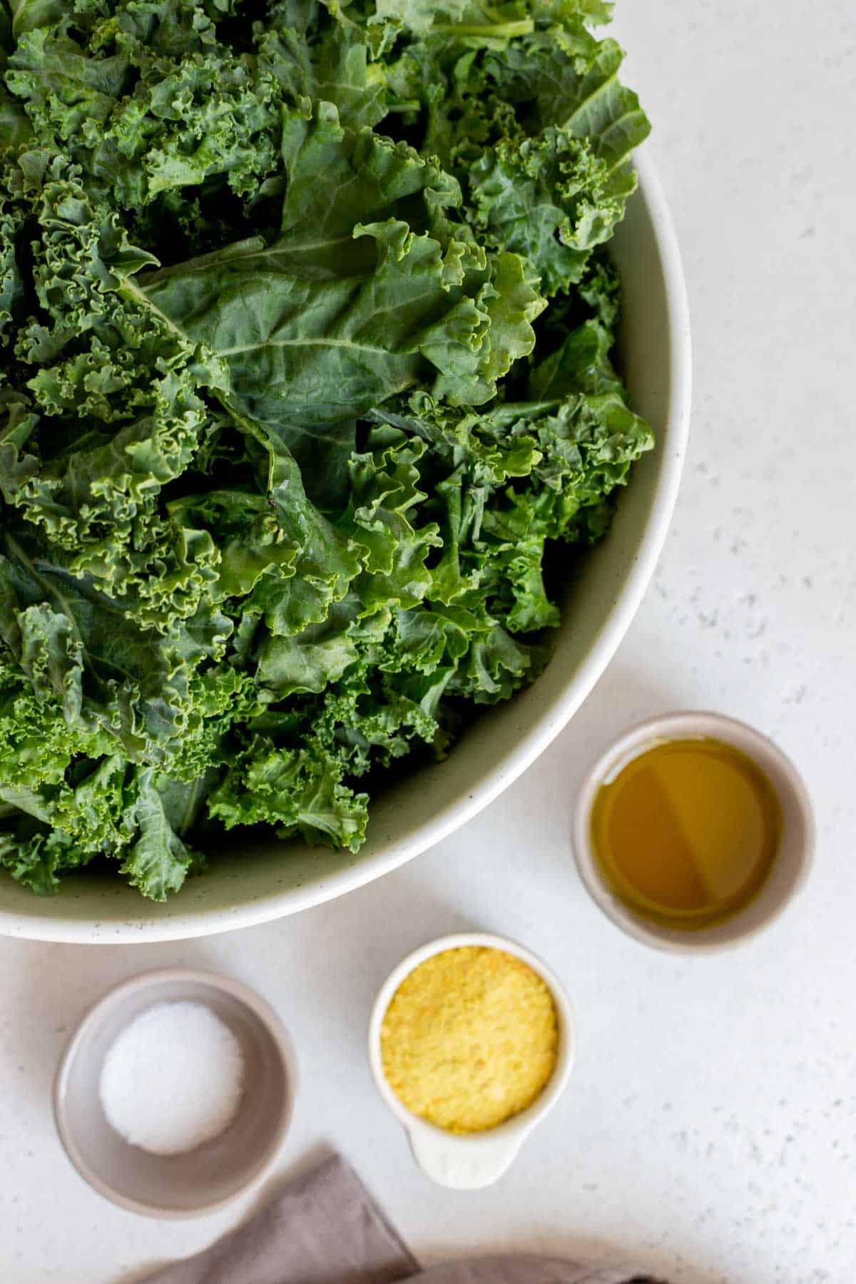 Ingredients needed to make kale chips with nutritional yeast.