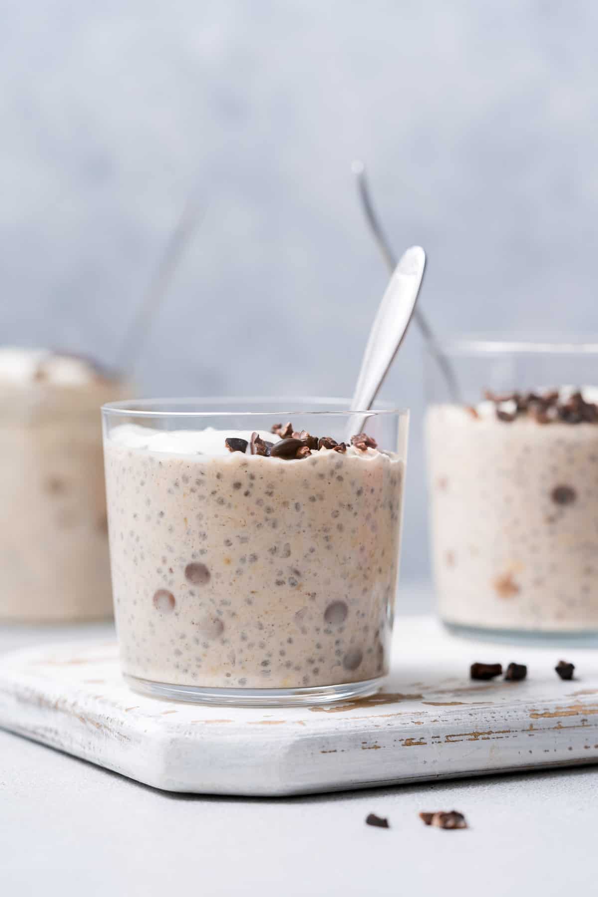 A jar of cookie dough overnight oats with a spoon inside.