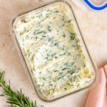 A container containing homemade rosemary butter.