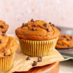 A profile view of a pumpkin protein muffin on a tray.