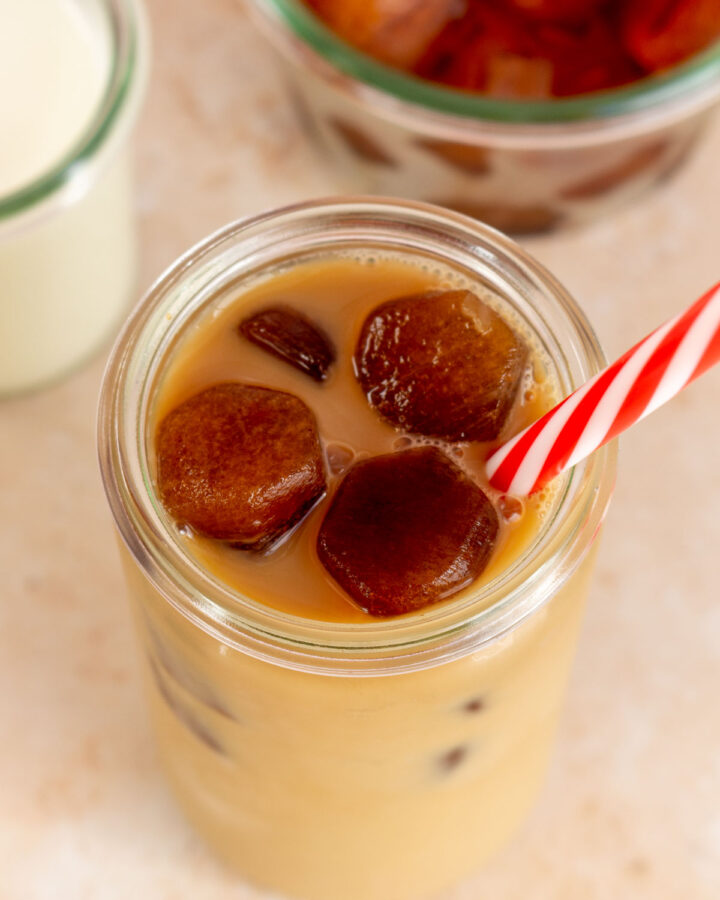 Overhead view of a glass of coffee with coffee ice cubes.