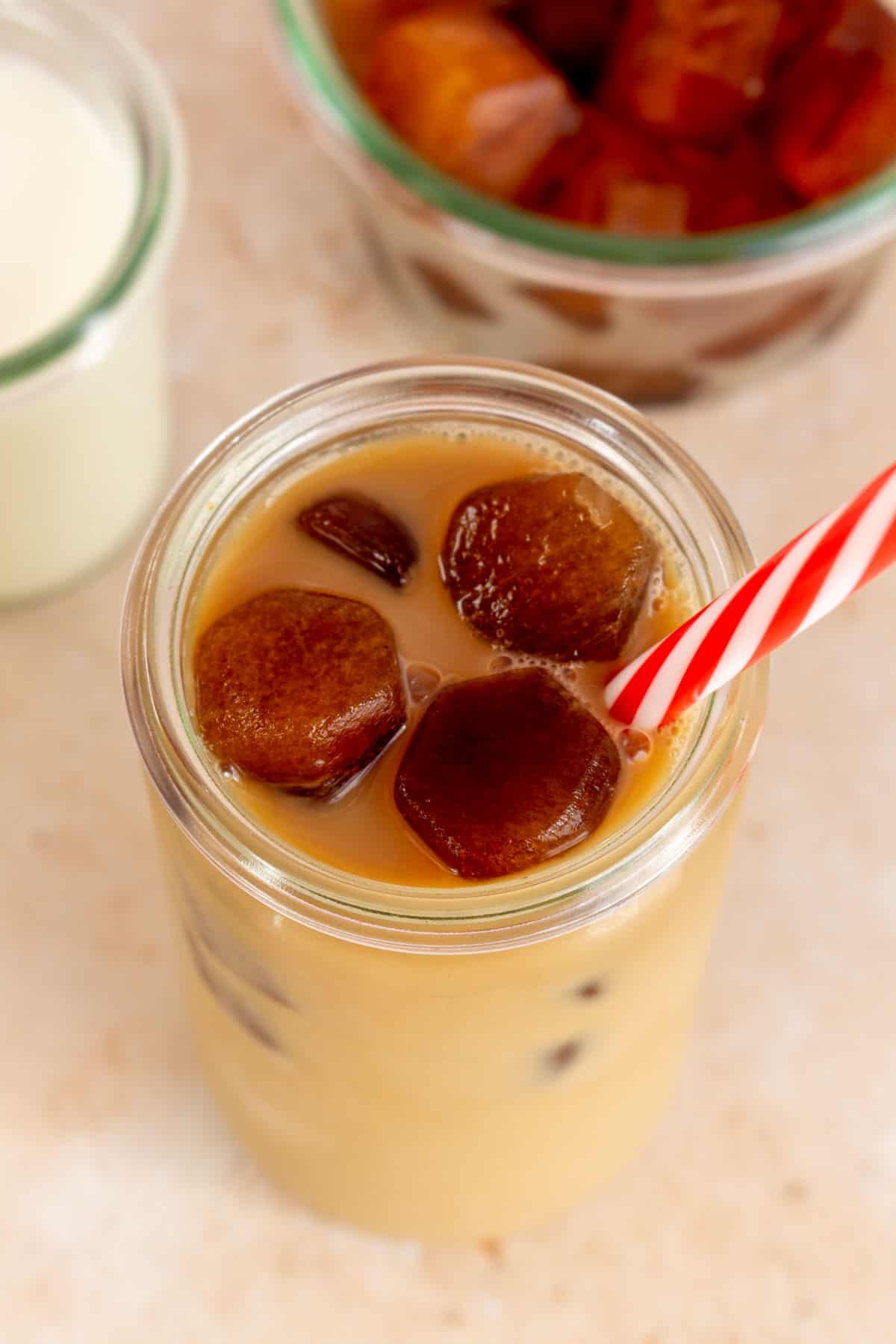 Overhead view of a glass of coffee with coffee ice cubes.