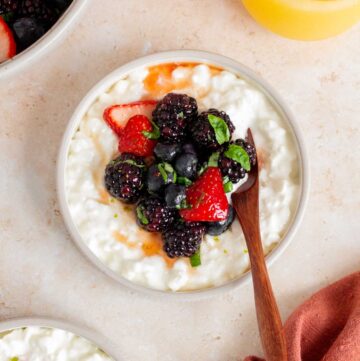Overhead view of a plate of cottage cheese with fruit.