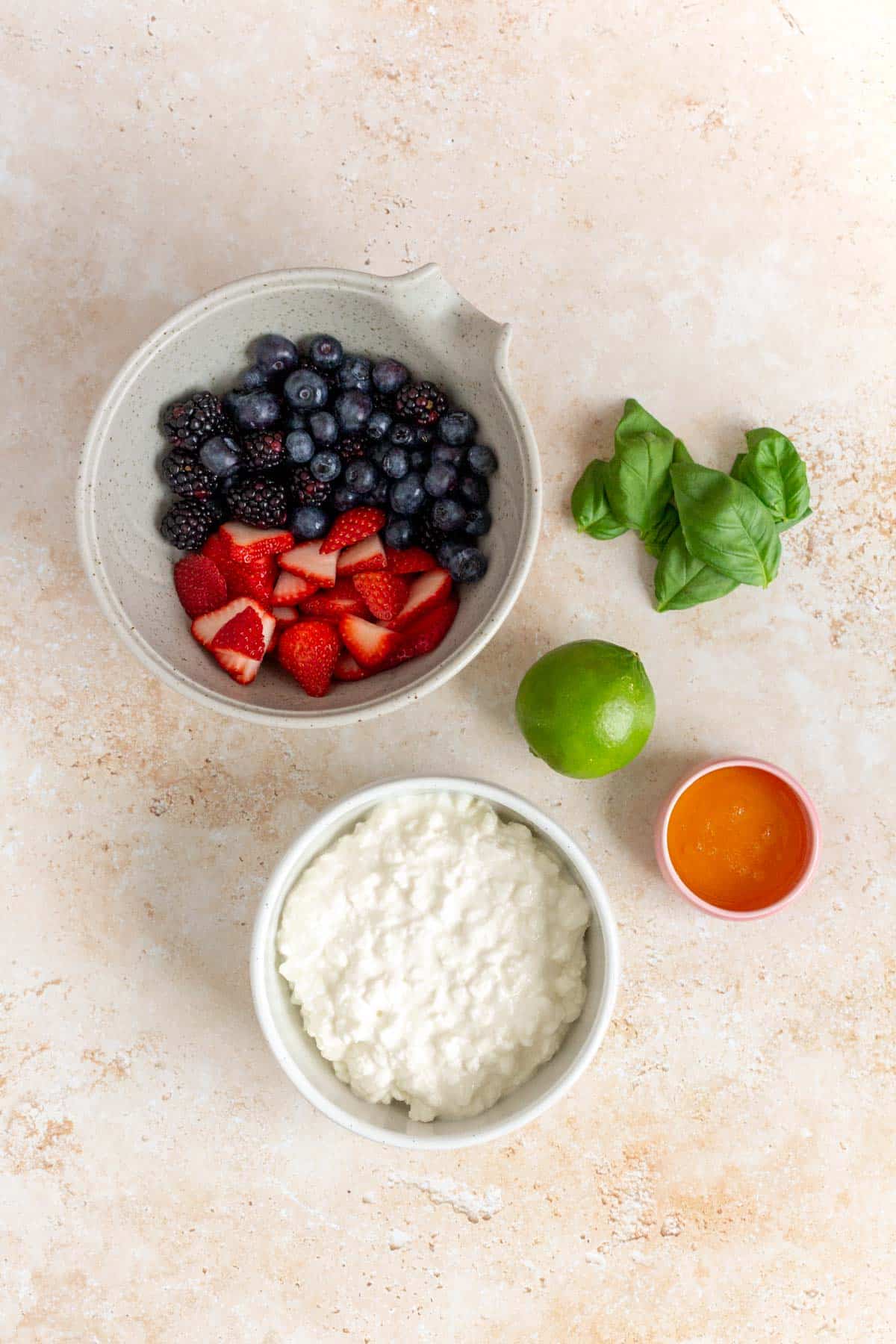 Ingredients needed to make cottage cheese with fruit.