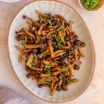 Overhead view of stir fried shimeji mushrooms.