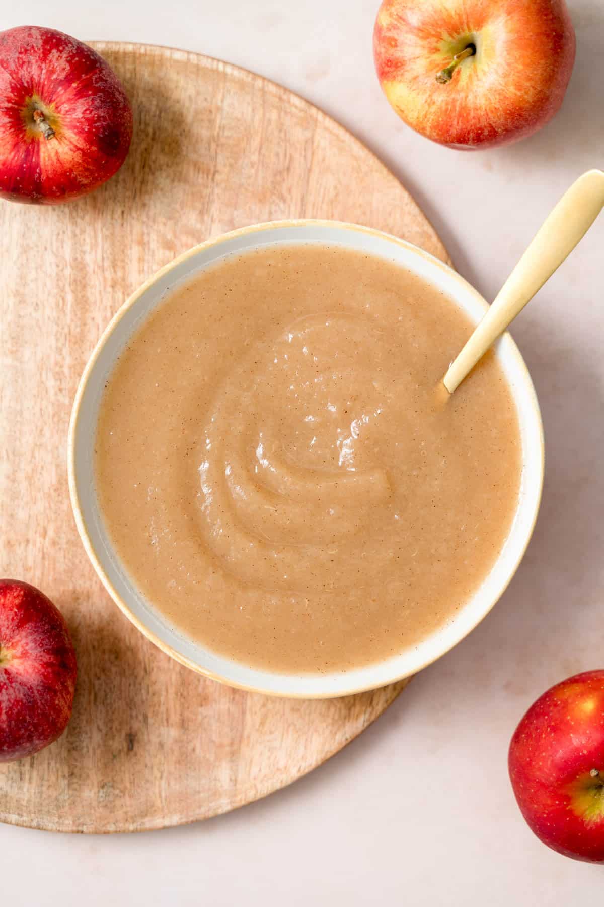 An overhead view of a bowl of unsweetened applesauce.