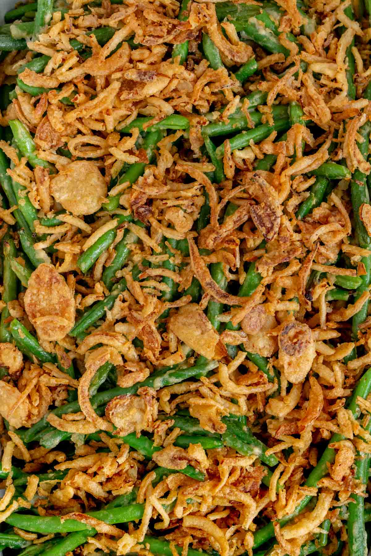 Overhead view of a green bean casserole topped with crispy onions.