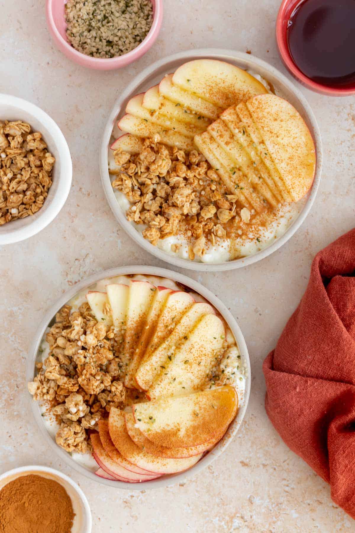 Overhead view of two cottage cheese apple cinnamon bowls.