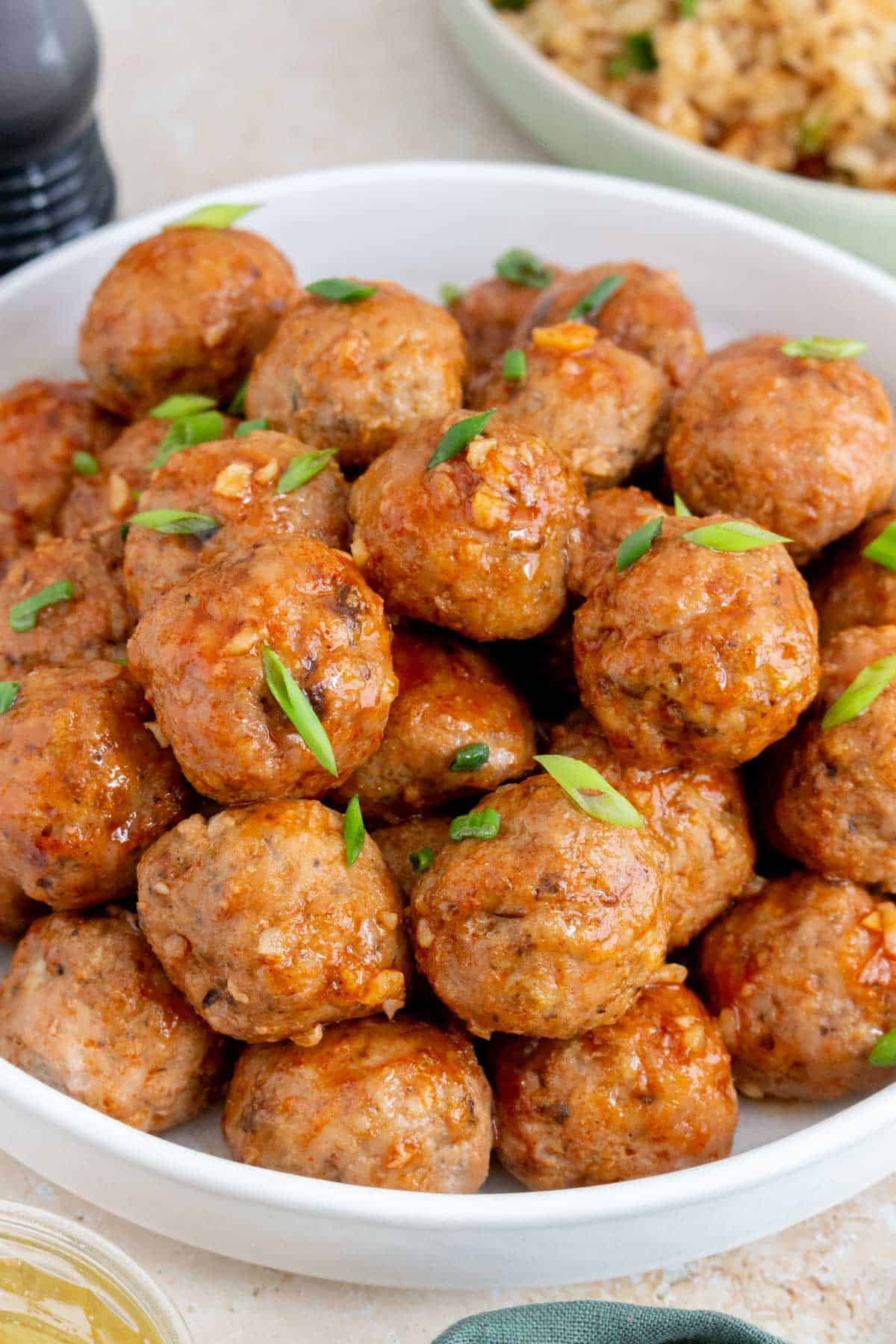 A close up view of honey sriracha meatballs on a plate.