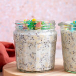 A profile view of a jar of cereal milk overnight oats topped with cereal.
