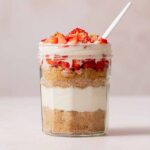 A protein cheesecake jar with a spoon tucked in.