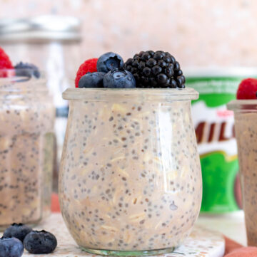 A jar of milo overnight oats topped with fresh berries.