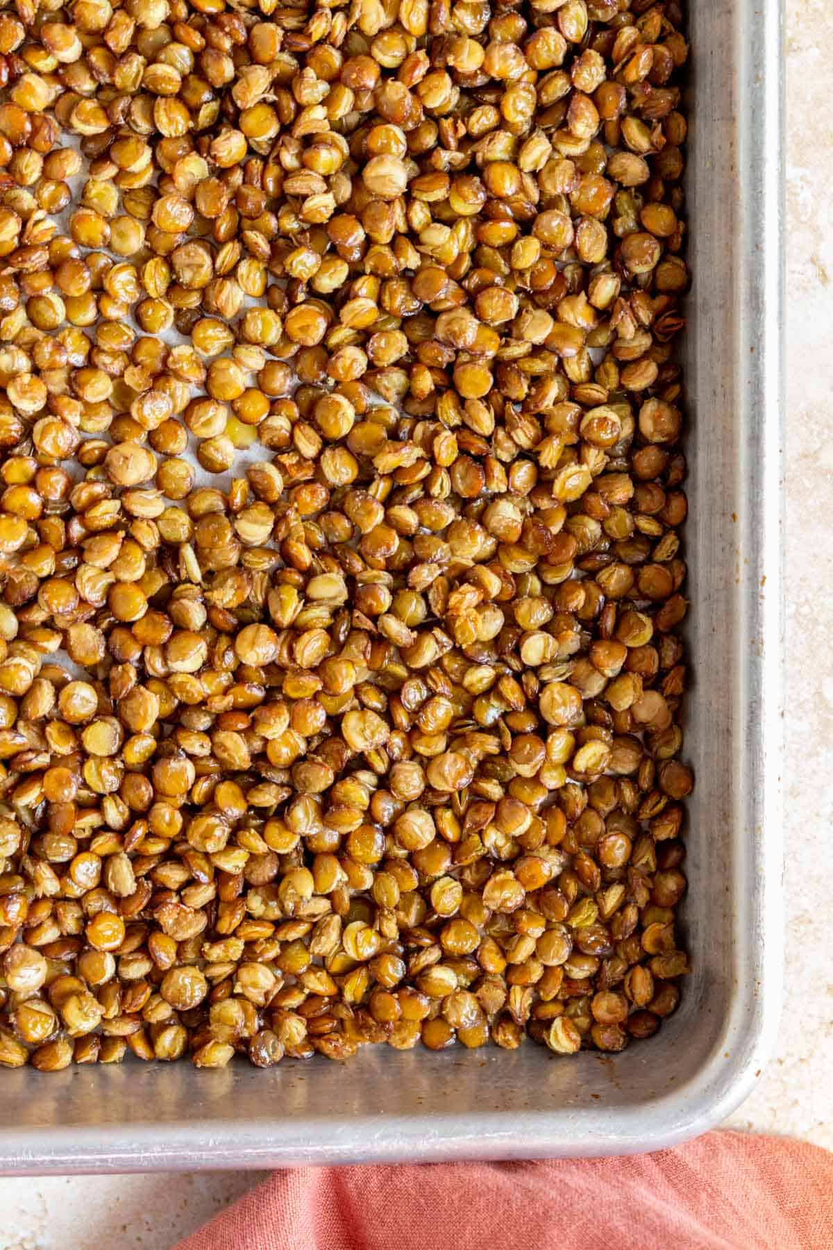 A close up view of crispy lentils in a sheet pan.