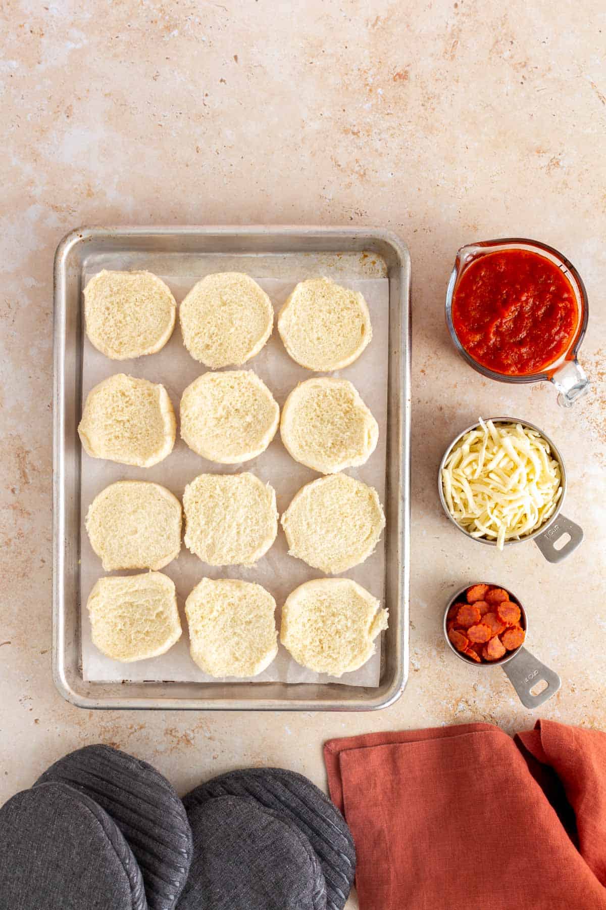 Ingredients needed to make homemade mini pizza bagels.