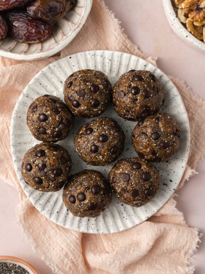 Overhead view of a plate of 8 nut date balls.