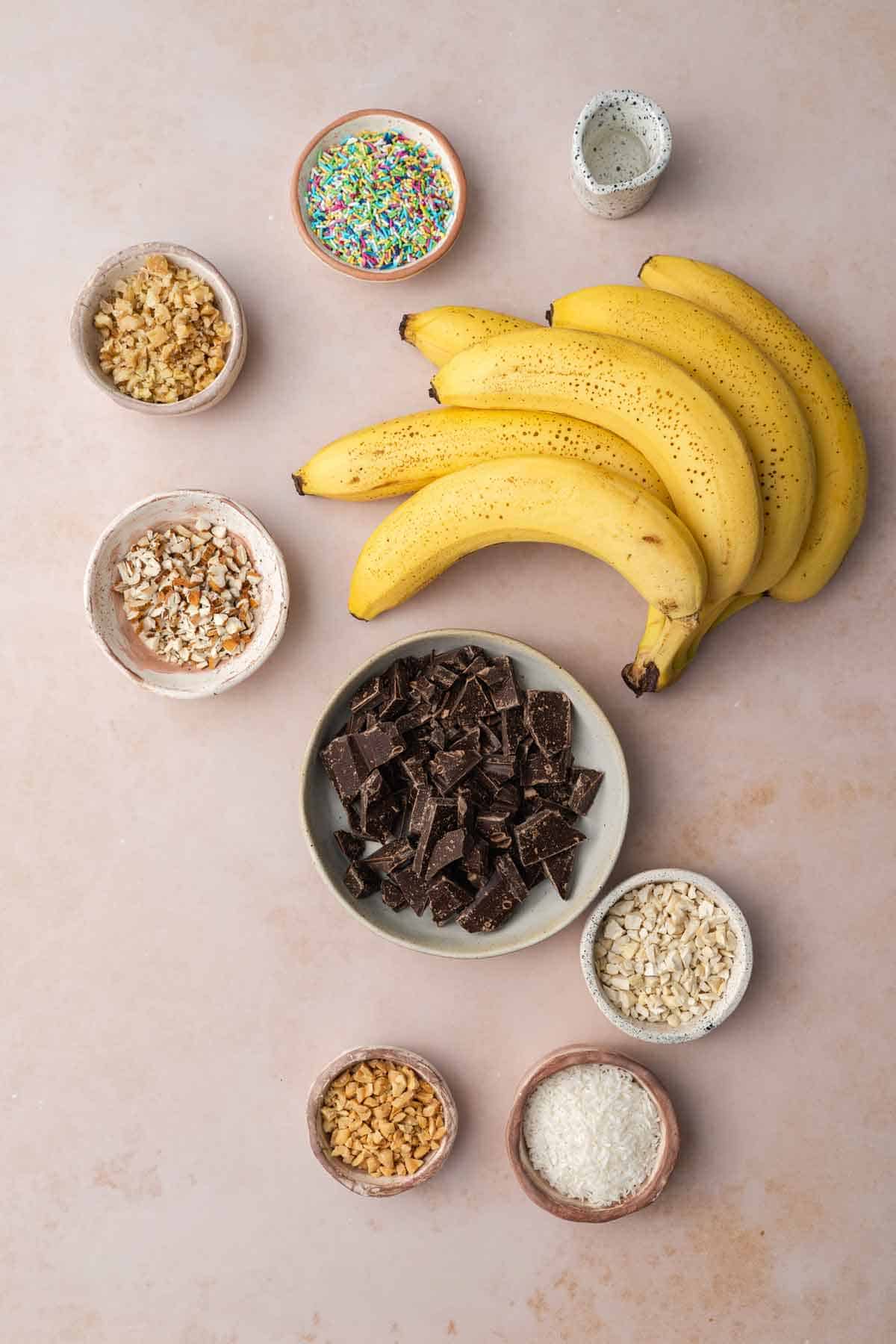 Ingredients needed to make chocolate covered banana popsicles.