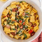 Overhead view of a pot of chorizo and spinach pasta with parmesan.