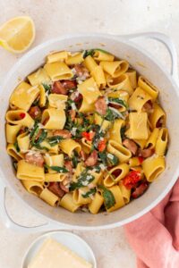 Overhead view of a pot of chorizo and spinach pasta with parmesan.