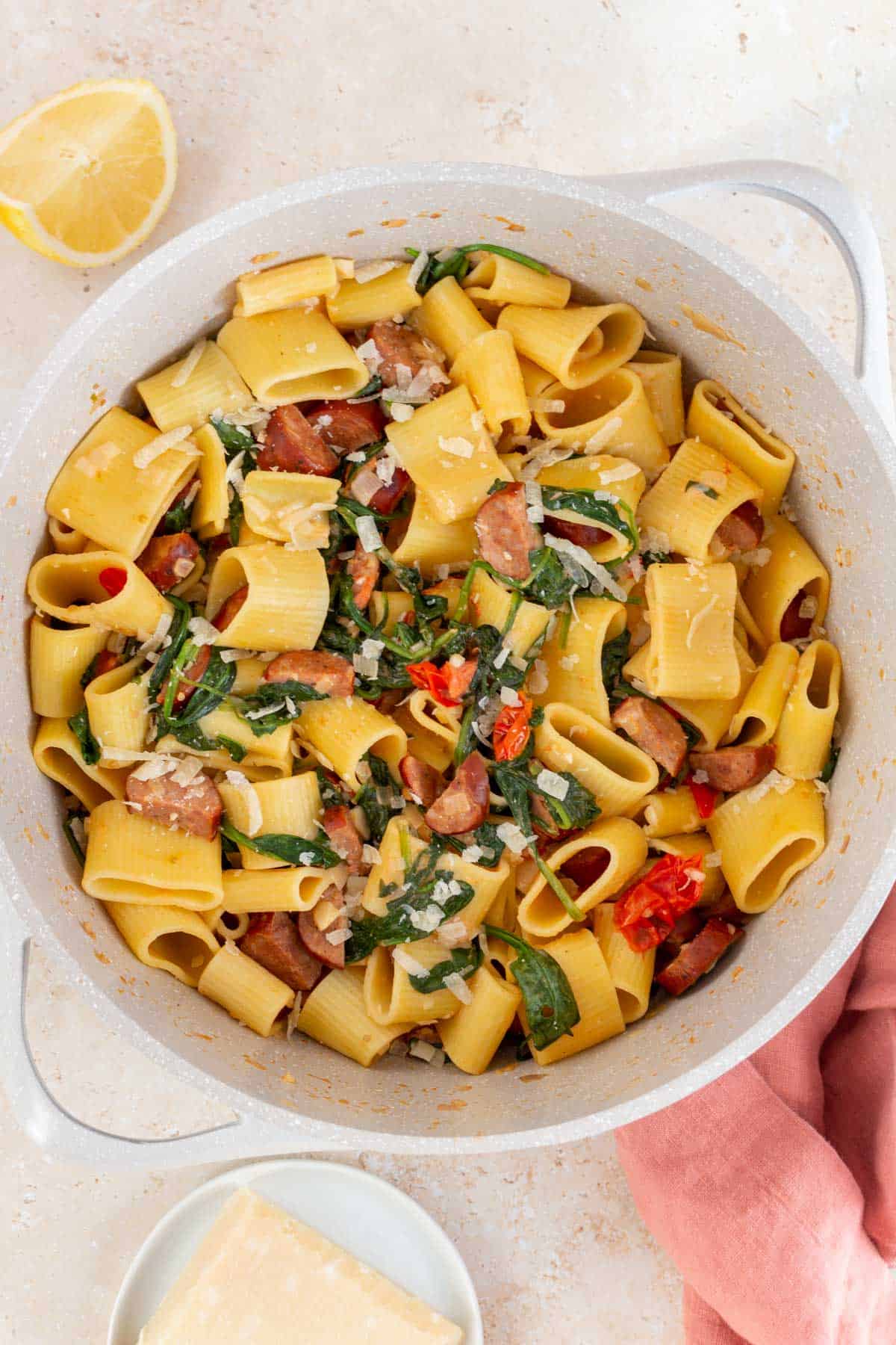 Overhead view of a pot of chorizo and spinach pasta with parmesan.