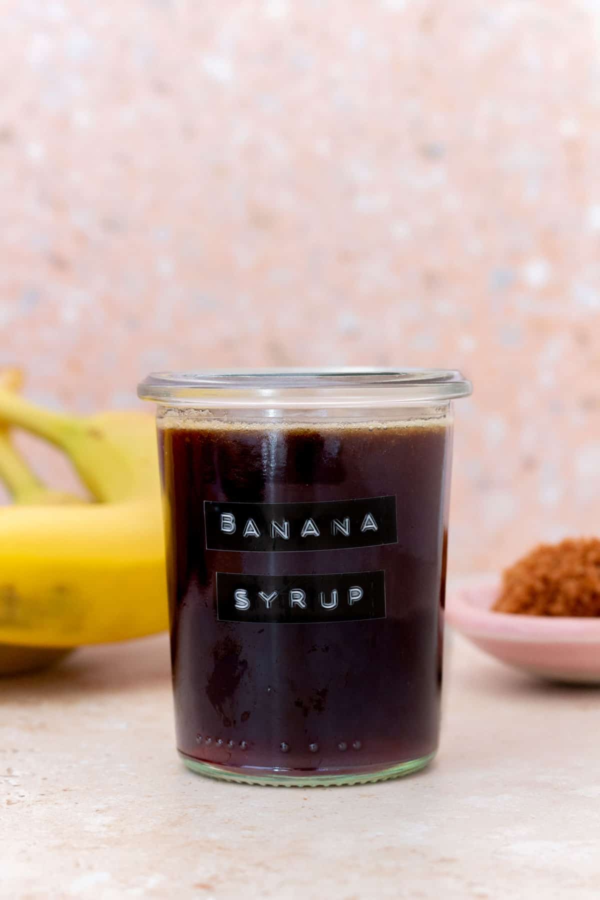 A jar of homemade banana simple syrup.