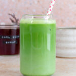 A glass of earl grey matcha with a straw.