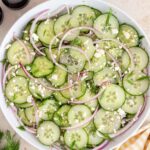 Overhead view of a bowl of cucumber feta salad.