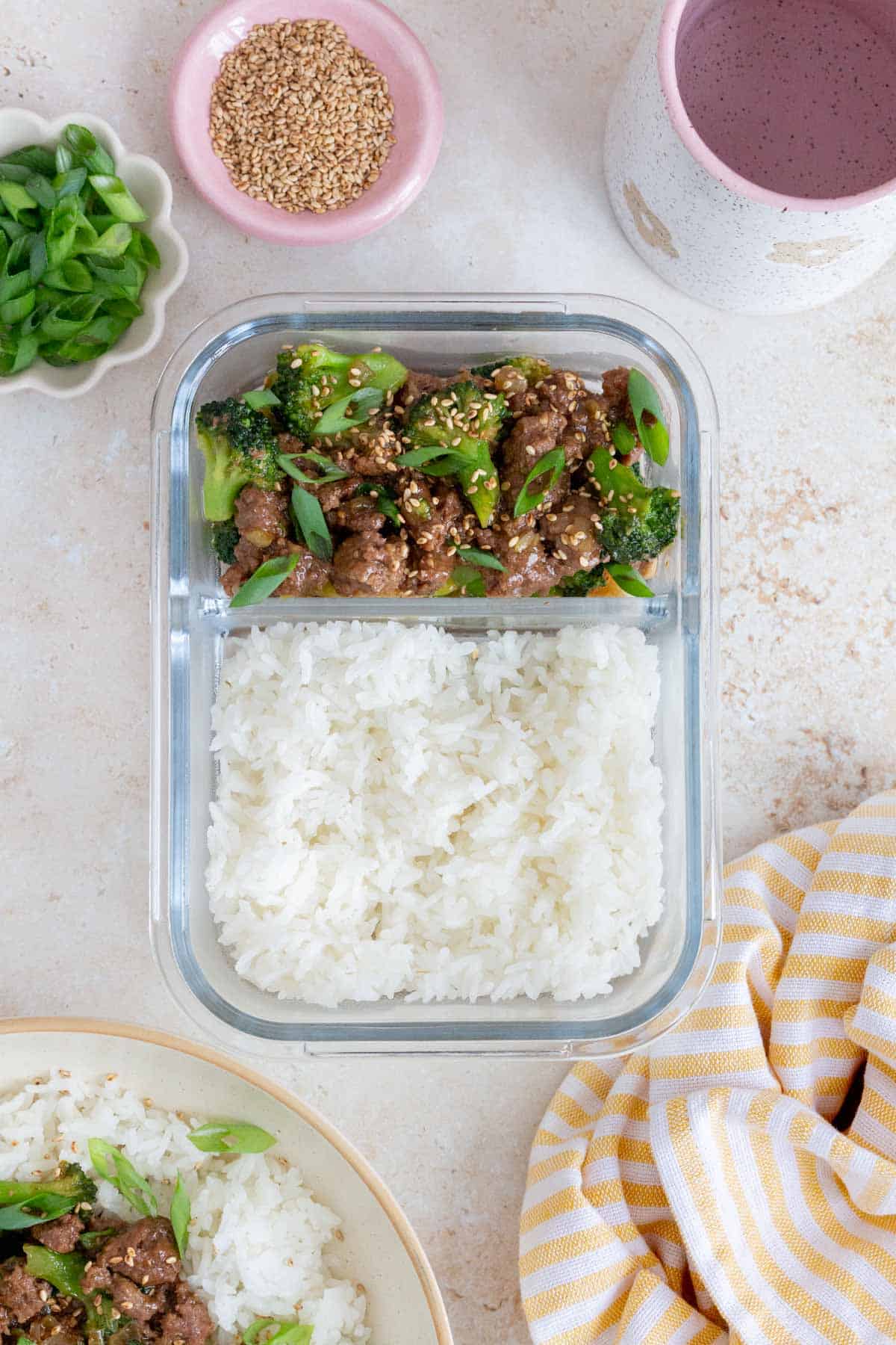A meal prep container with rice and ground beef and broccoli.