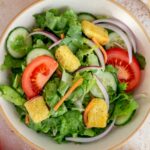 Close up view of a bowl of house salad.