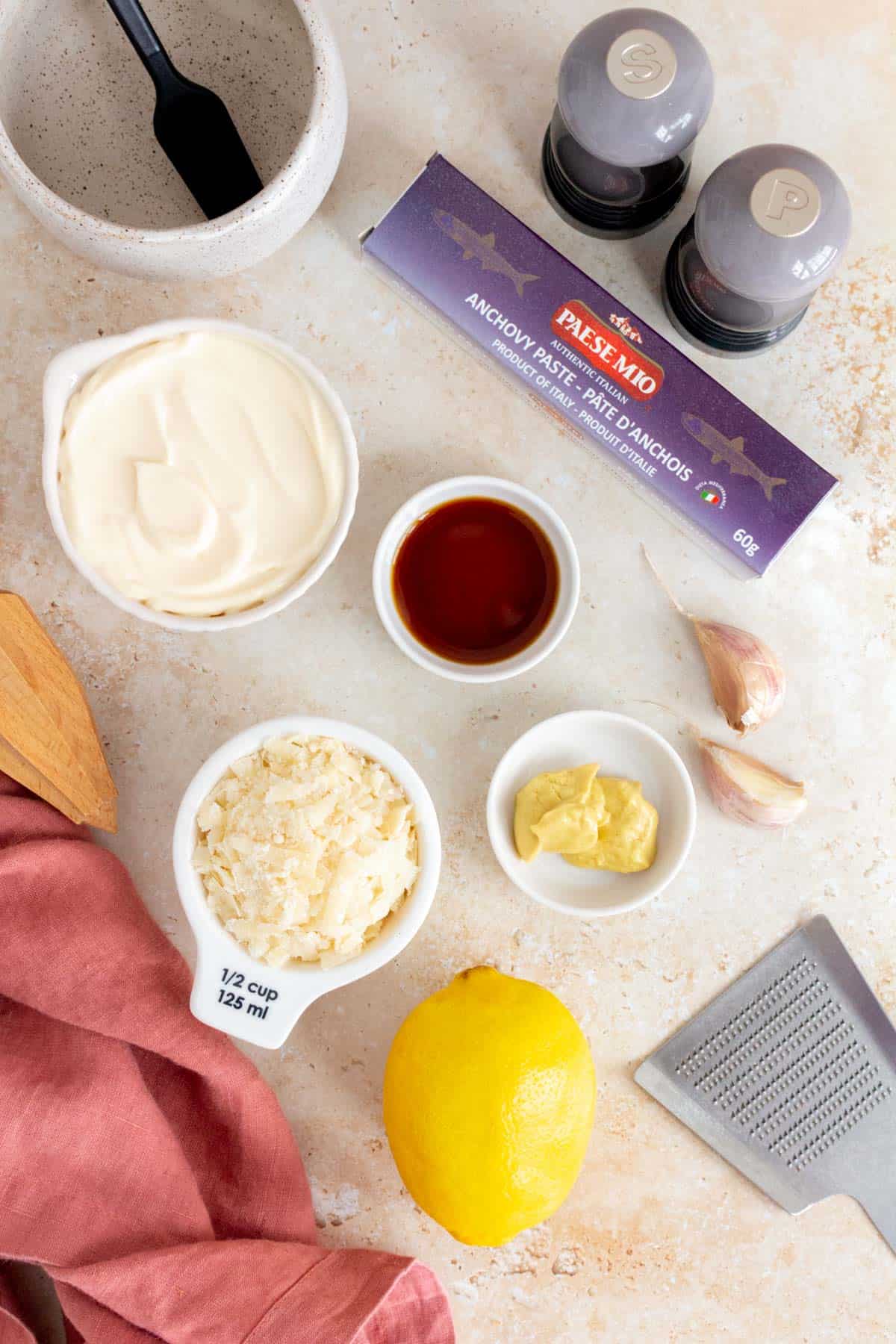 Ingredients needed to make homemade caesar salad dressing.