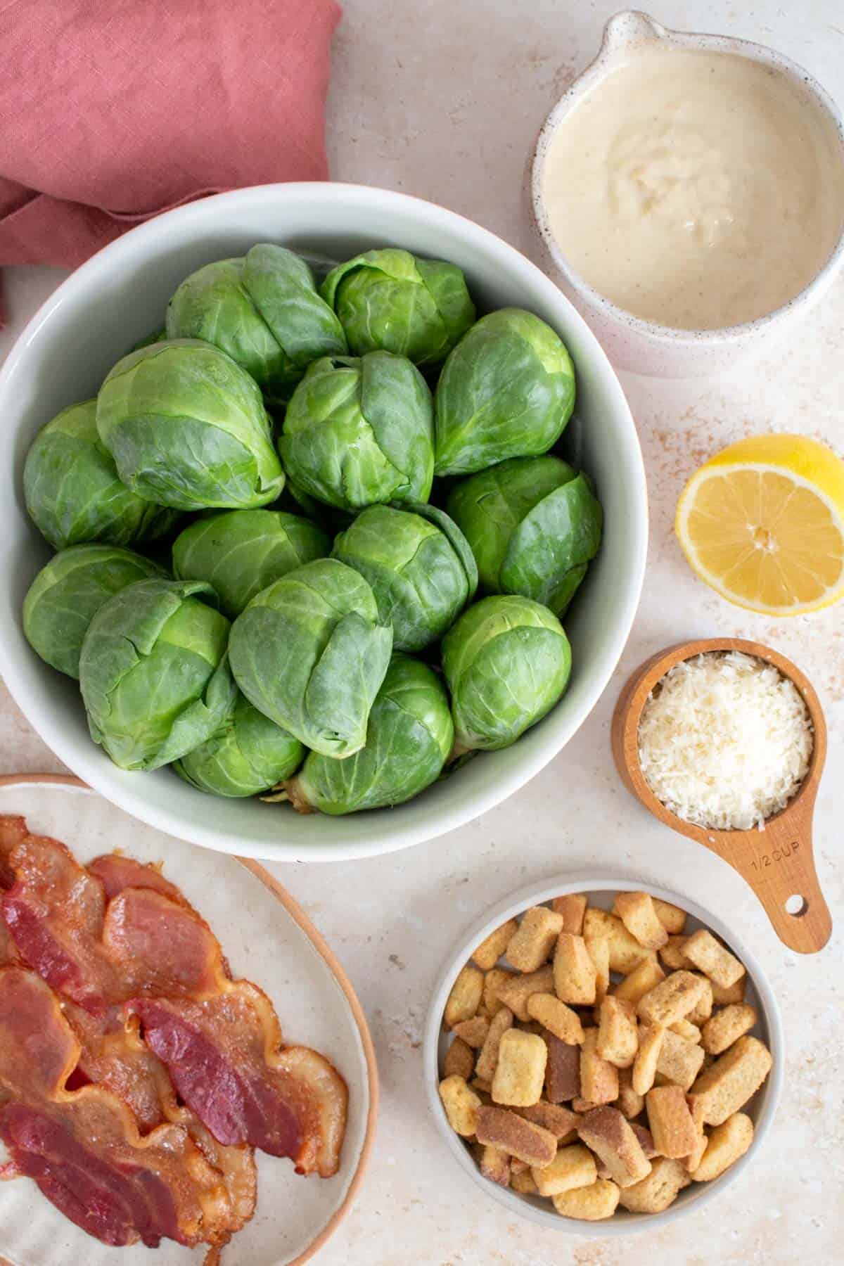 Ingredients needed to make a shaved brussels sprouts caesar salad.
