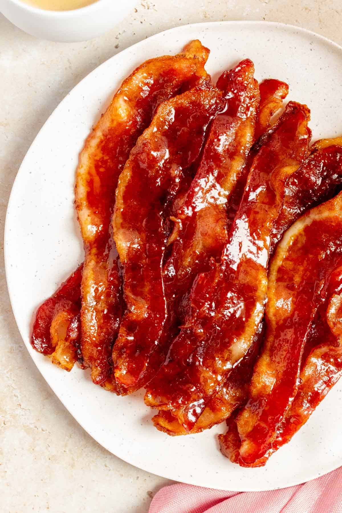A close up view of a plate of brown sugar bacon.
