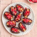 Overhead view of peanut butter and jelly stuffed dates on a plate.