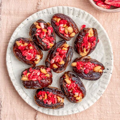 Overhead view of peanut butter and jelly stuffed dates on a plate.