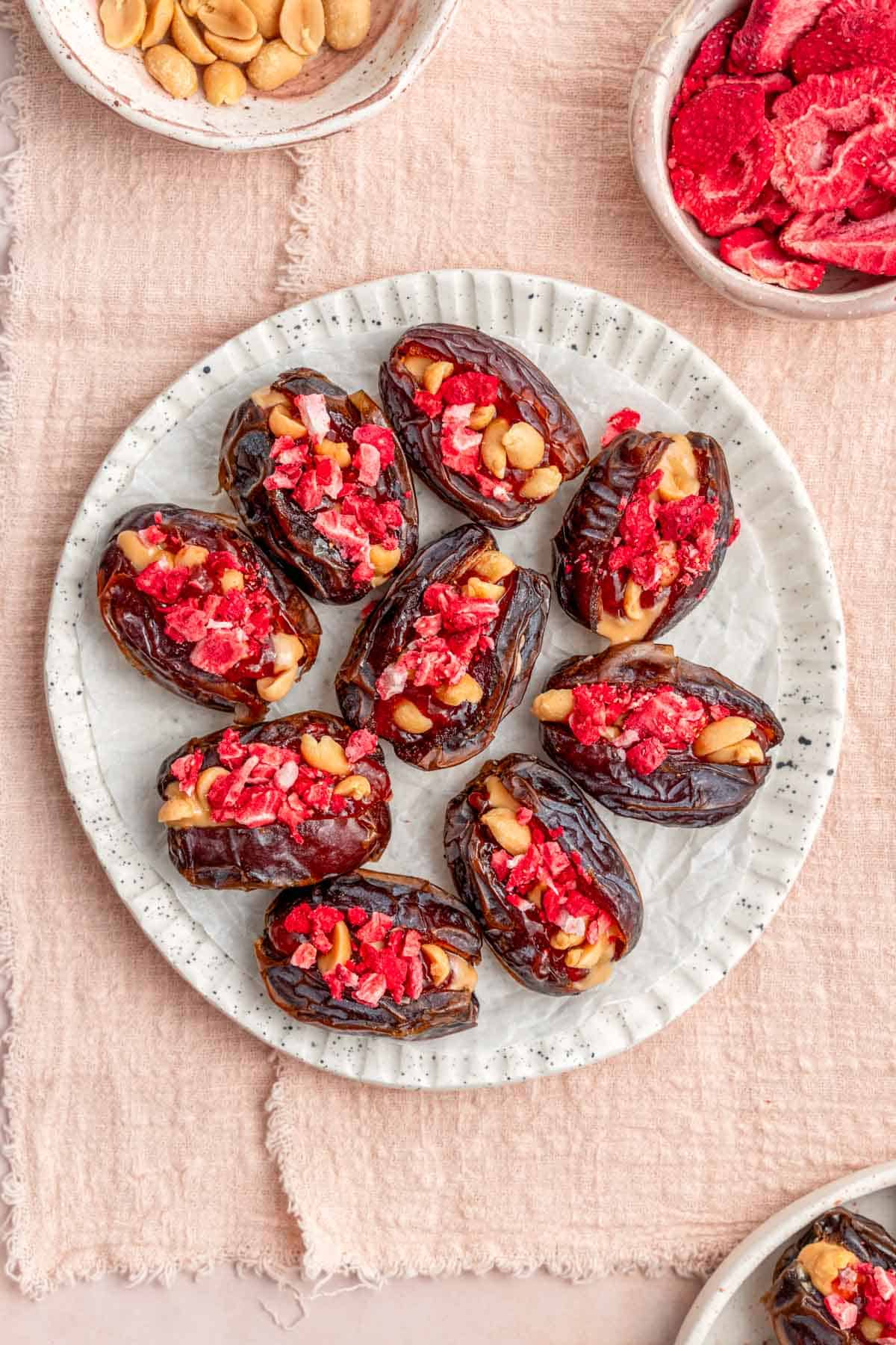 Overhead view of peanut butter and jelly stuffed dates on a plate.