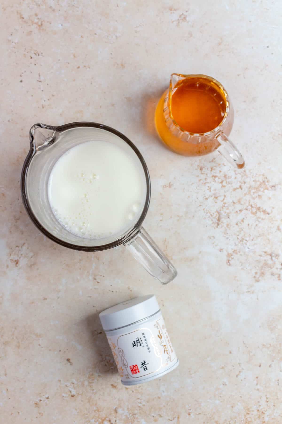 Ingredients needed to make jasmine matcha latte.