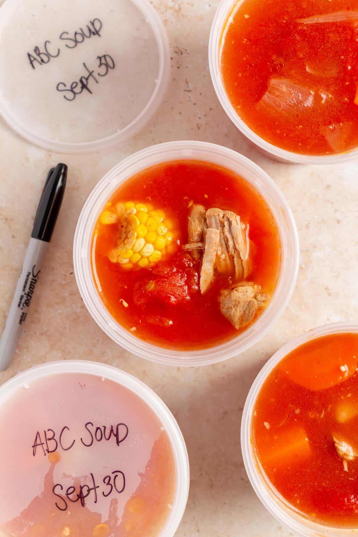 ABC soup added to a freezer-safe container to be frozen.