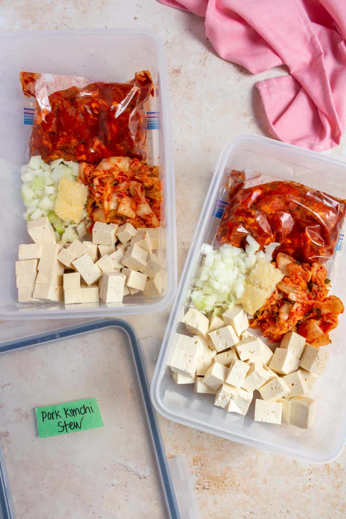 Kimchi stew ingredients added to containers for the freezer.