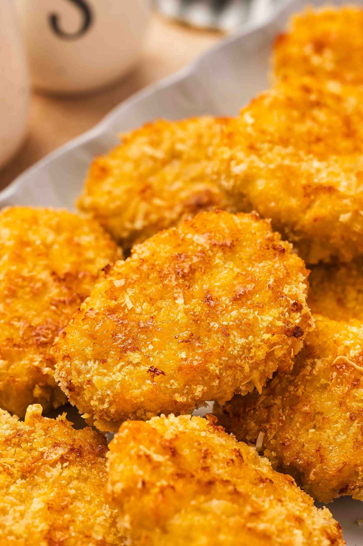Cheesy chicken nuggets on a platter.