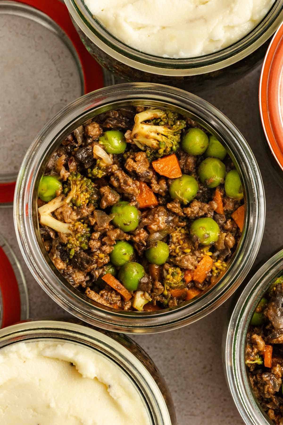 Overhead view of mason jar shepherd's pie before the mashed potatoes are added.