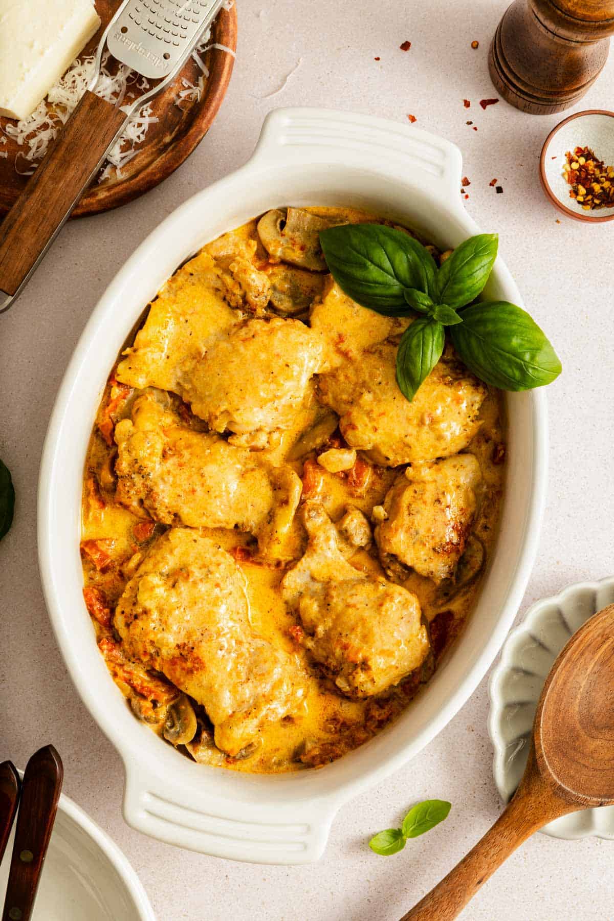 An oval serving platter with Instant Pot creamy sun-dried tomato parmesan chicken.