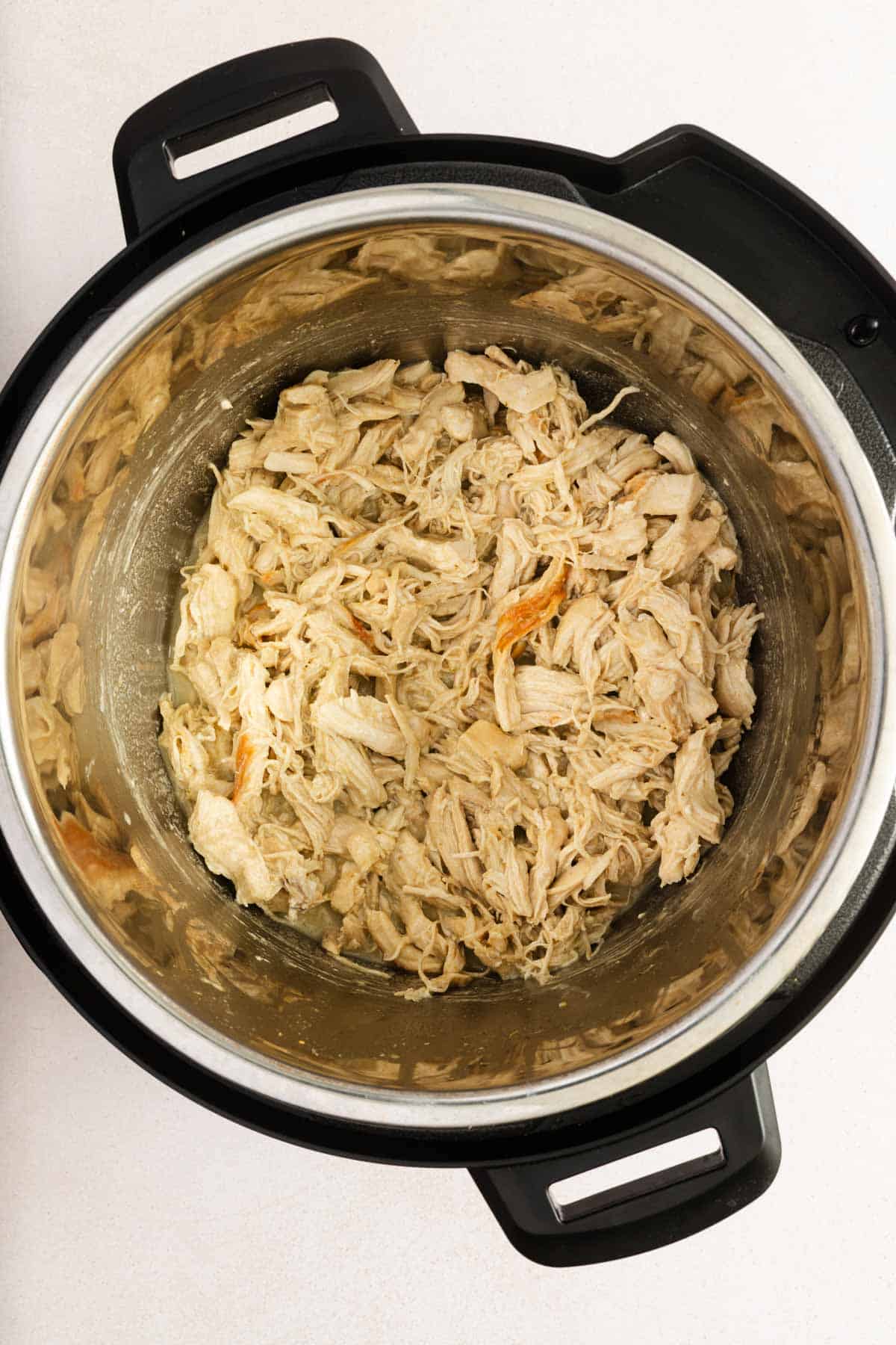 Overhead view of shredded chicken in an instant pot.
